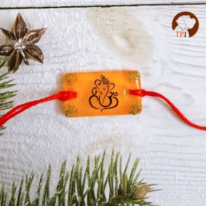 Resin Sinduri Ganesha Blessings Rakhi | Golden Aura Ganpati Rakhi | Sacred Om & Ganesha Rakhi | Radiant Ganpati Rakhi with Gold Flakes | Spiritual Sinduri Rakhi | Vibrant Ganesha Blessings Rakhi - Divine Orange Ganesha Rakhi